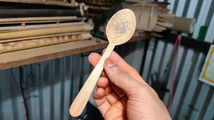Adding final touches to a bamboo spoon and fork for a smooth, polished finish. Adding final touches to a bamboo spoon and fork for a smooth, polished finish.