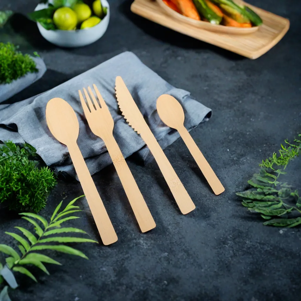 Eco friendly bamboo cutlery set on dark stone background Eco friendly bamboo cutlery set on dark stone background