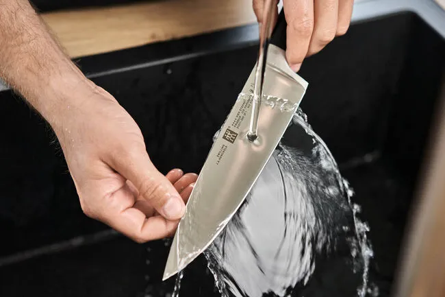 Handwashing knife to show proper cutlery care tips