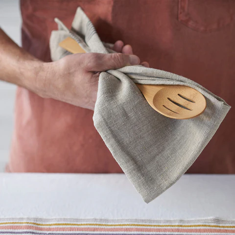 Hand drying bamboo utensils with soft cloth Hand drying bamboo utensils with soft cloth