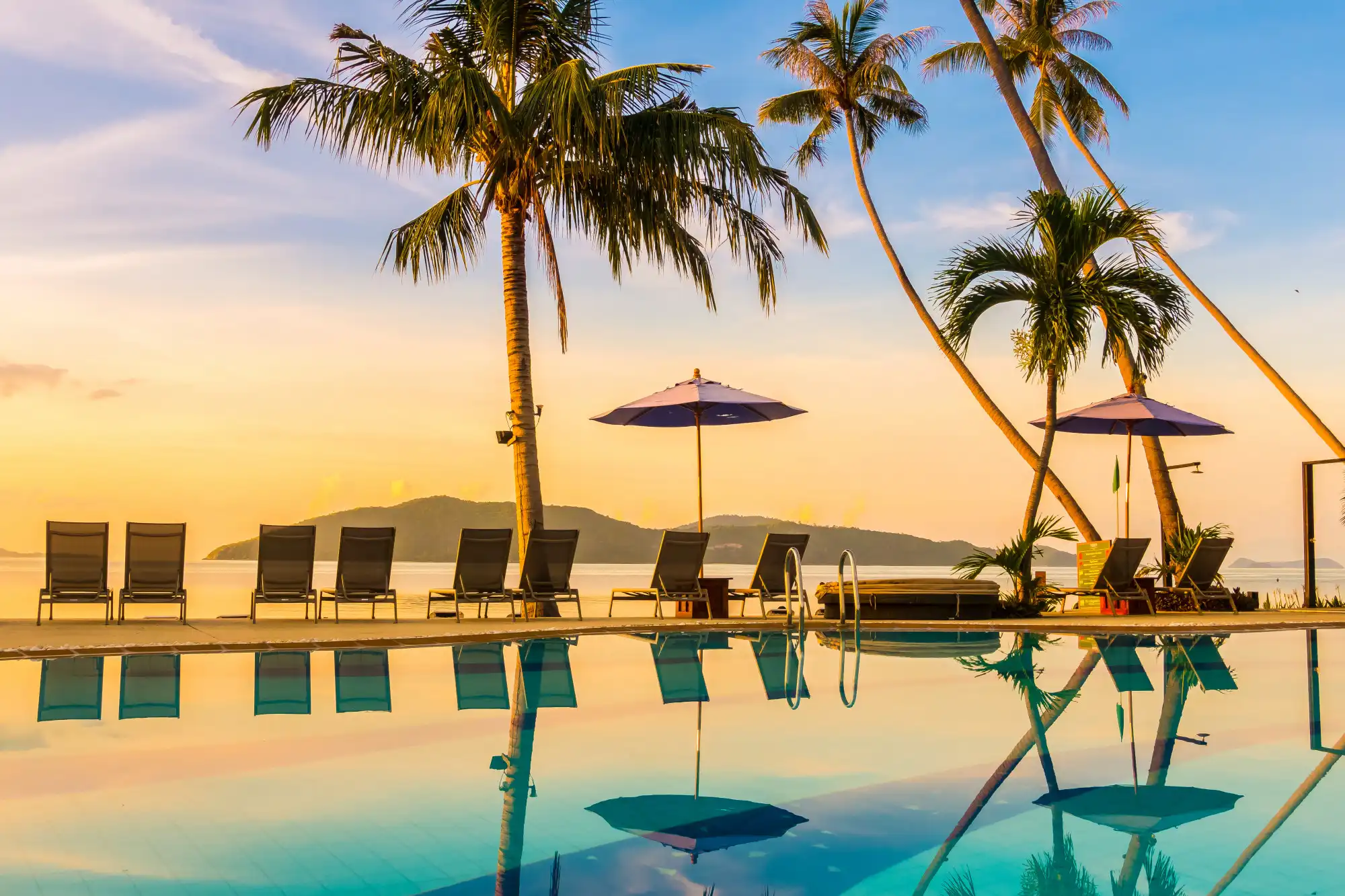 Resort hotel pool with ocean sunset view Resort hotel pool with ocean sunset view