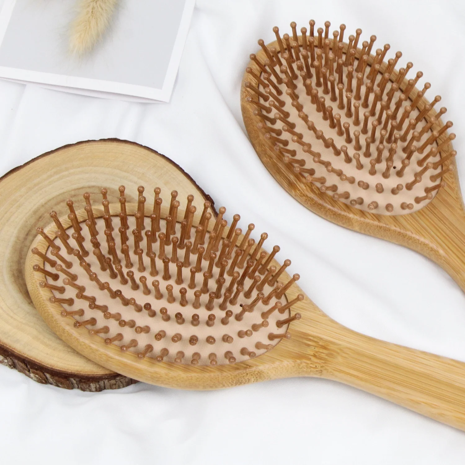 Two bamboo air cushion combs on wood slice decor Two bamboo air cushion combs on wood slice decor