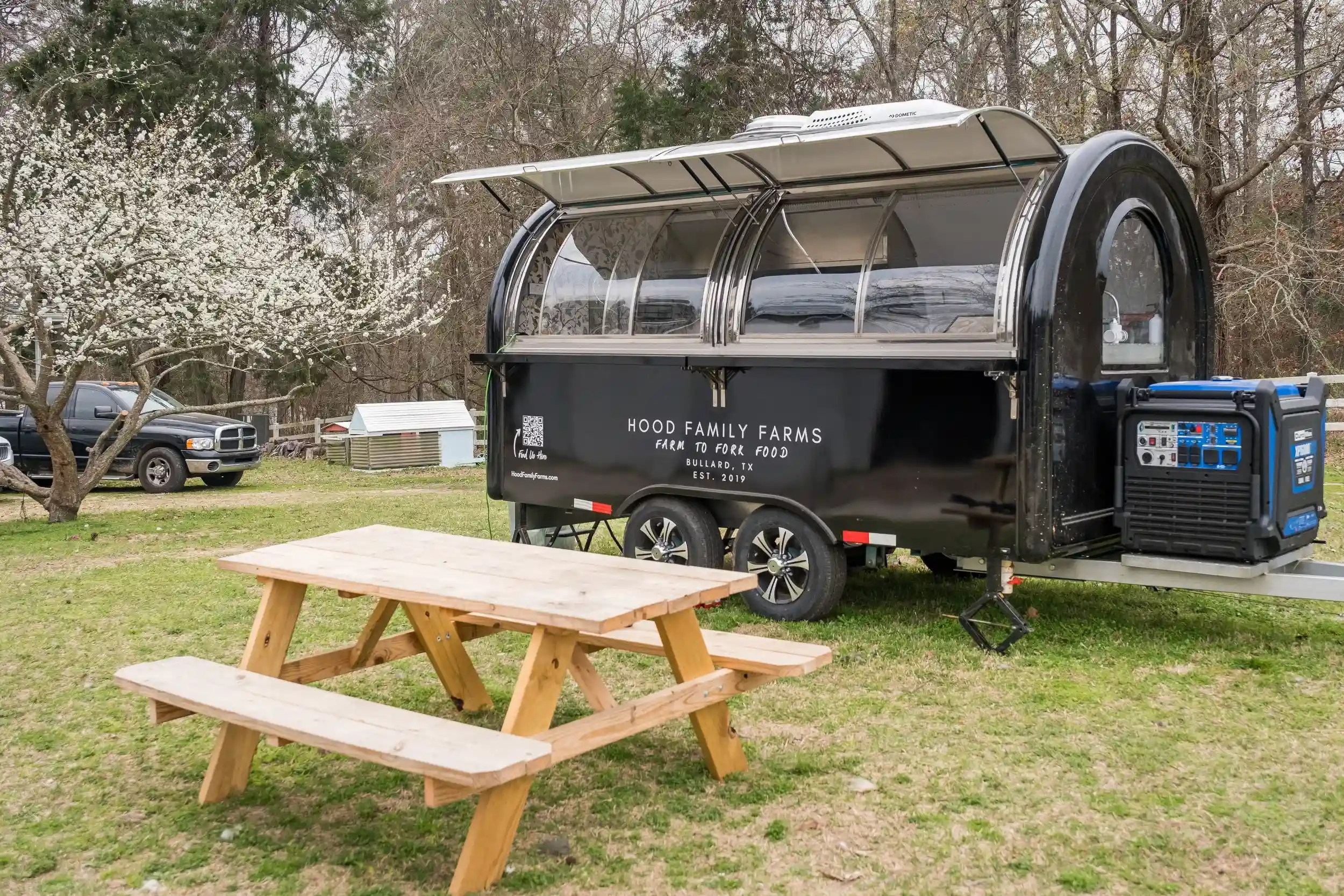 Farm to table trailer parked outdoors near picnic area Farm to table trailer parked outdoors near picnic area