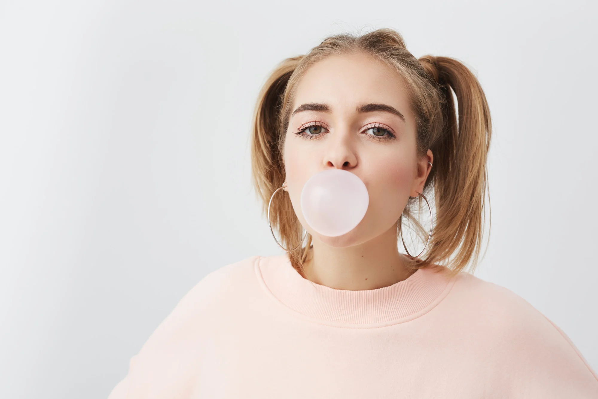 Girl blowing pink bubble gum Girl blowing pink bubble gum