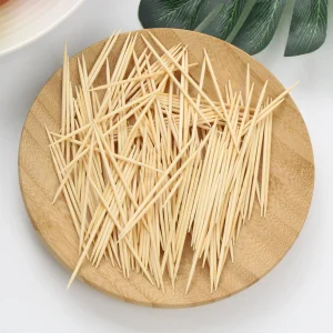 Natural bamboo toothpicks close up on round wooden plate