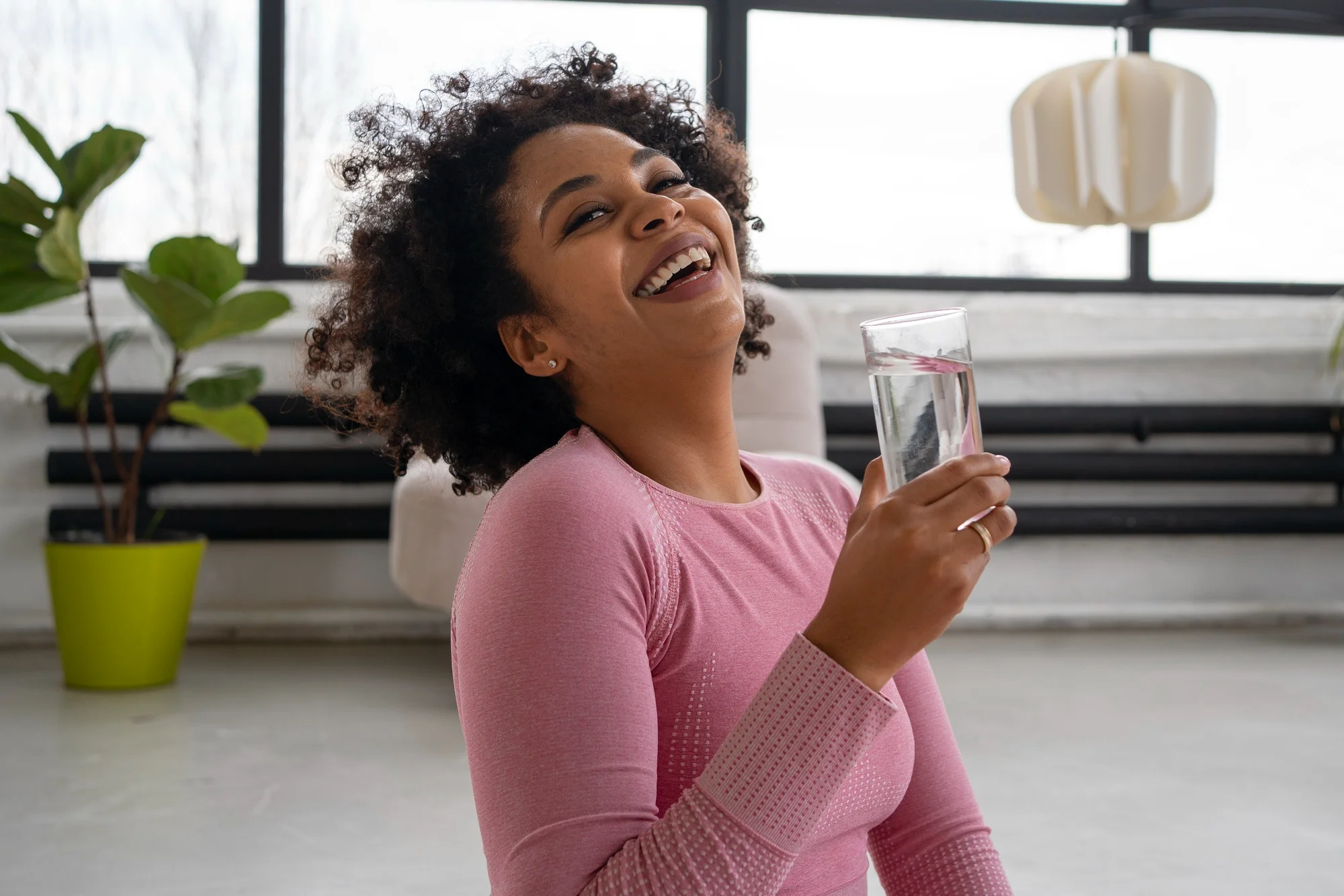 Smiling woman drinking glass of water Smiling woman drinking glass of water